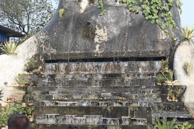 Instructor guiding a student through the steps of assembling a decorative waterfall.
