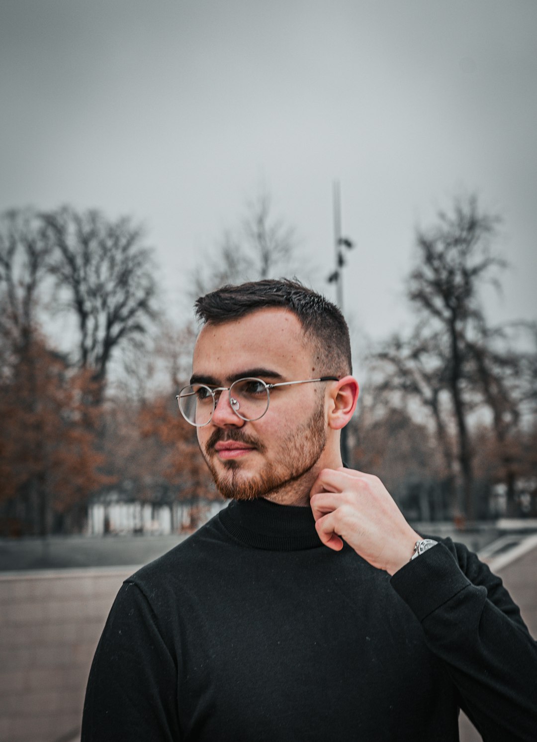 man in black crew neck long sleeve shirt wearing black framed eyeglasses