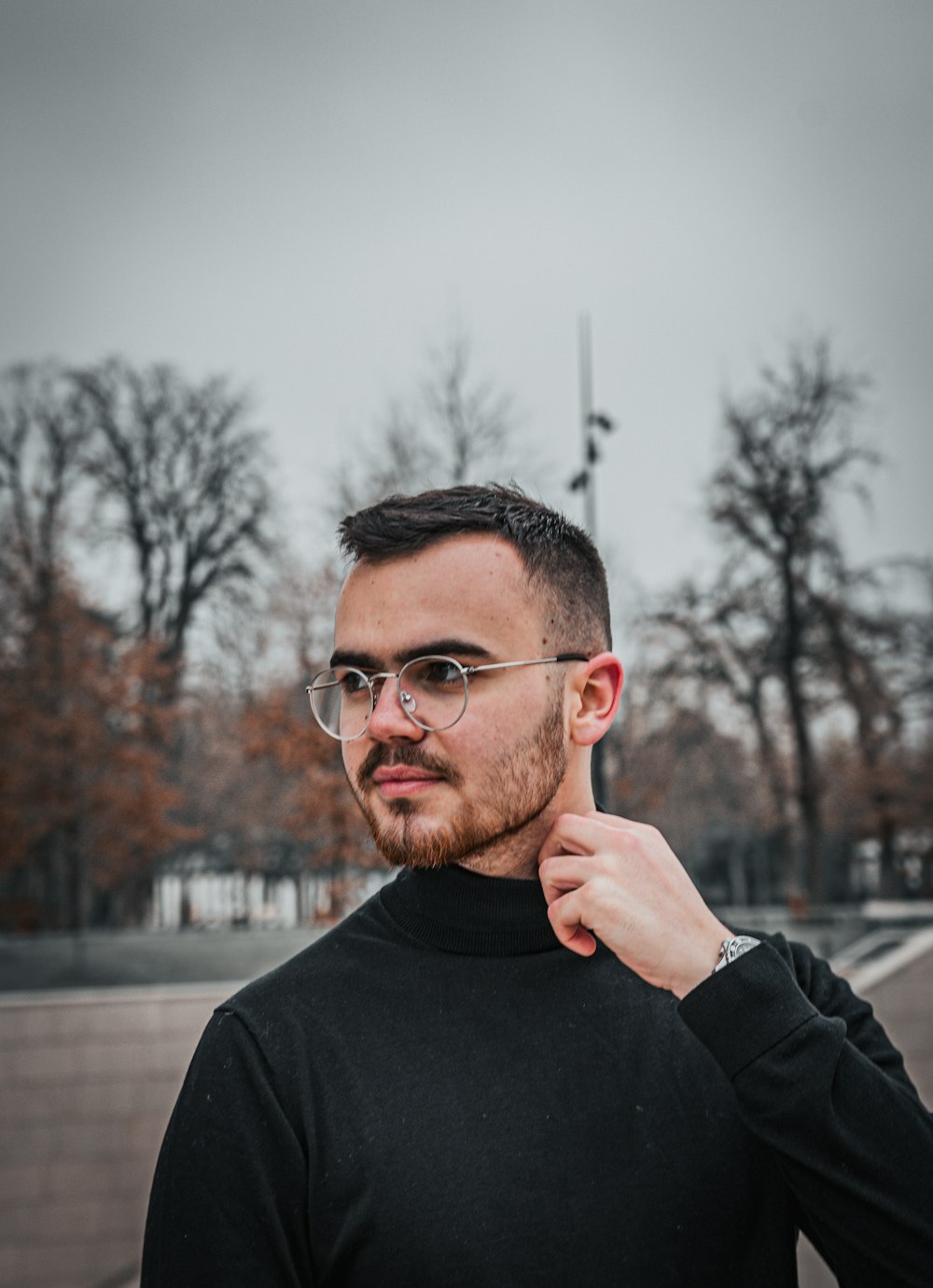 man in black crew neck long sleeve shirt wearing black framed eyeglasses