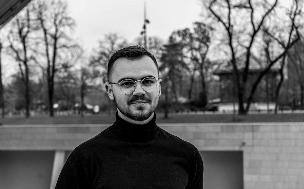 man in black crew neck shirt wearing eyeglasses