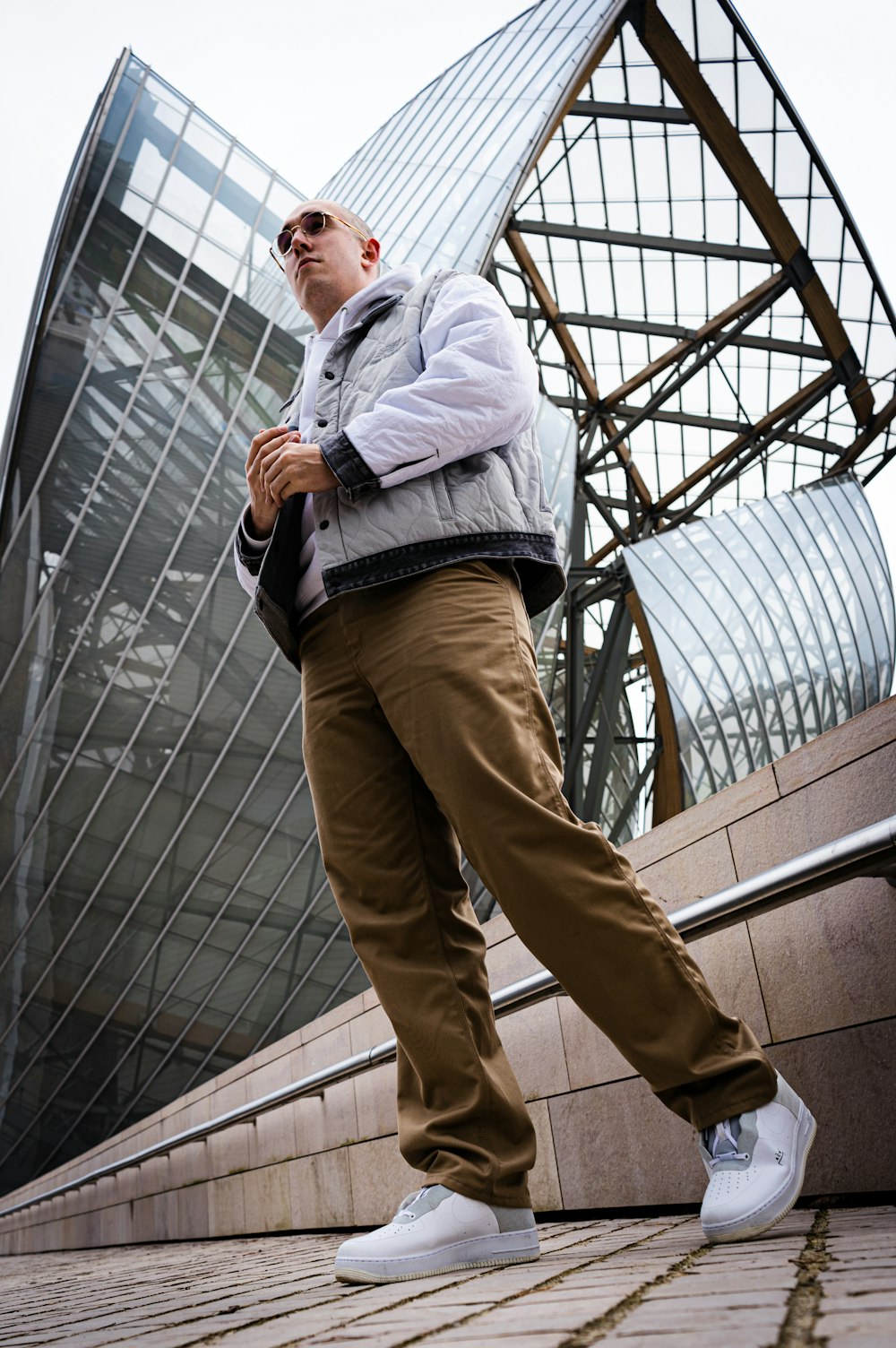 man in gray jacket and brown pants standing on yellow ladder