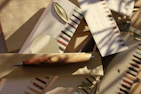 Student stationery pens in vibrant colors scattered on a wooden table.
