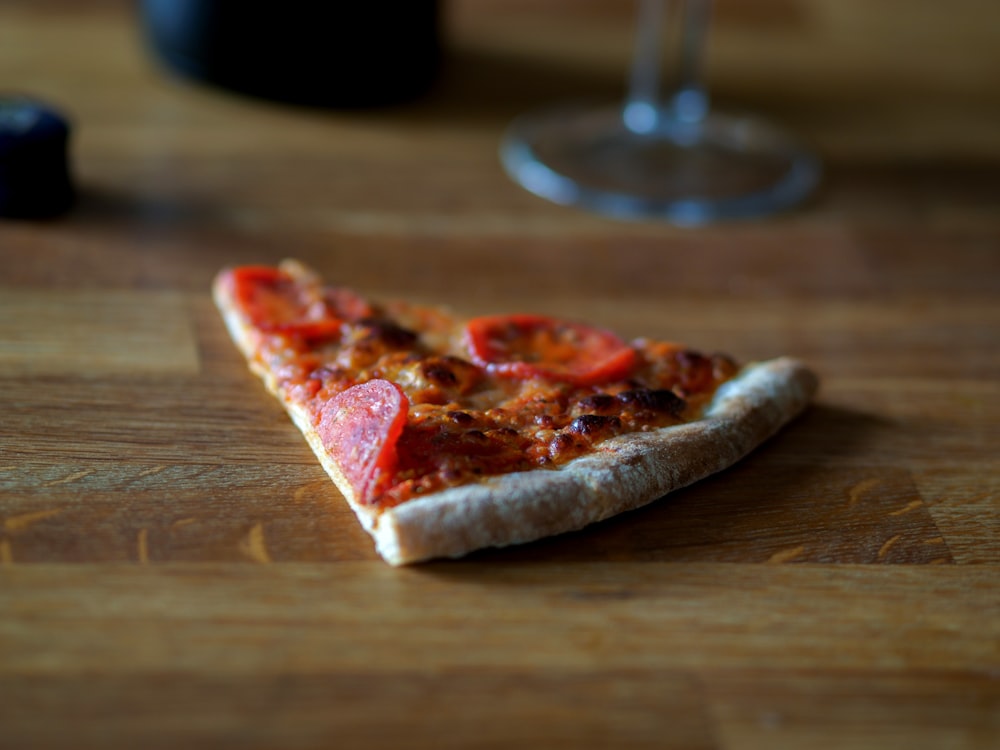 sliced pizza on brown wooden table