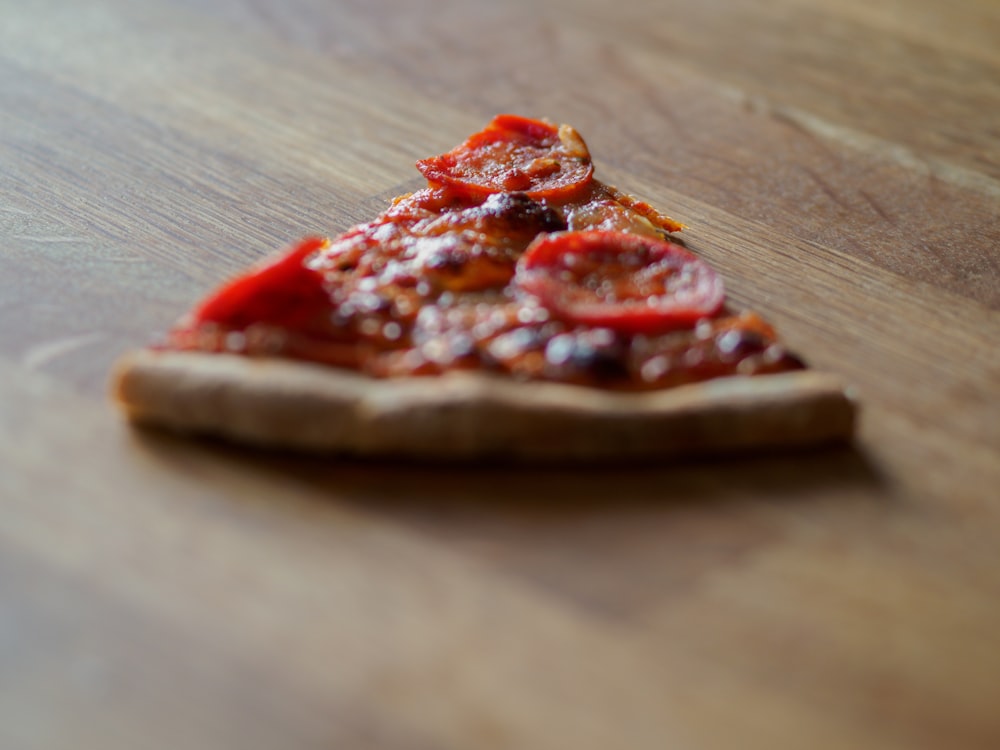 sliced pizza on brown wooden table