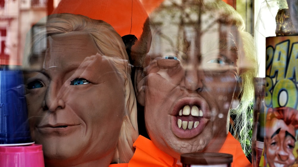 man in orange polo shirt beside woman in black framed eyeglasses