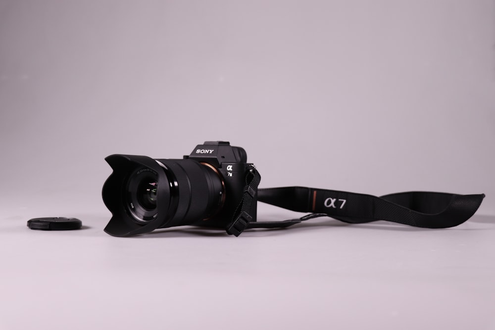 black nikon dslr camera on white surface