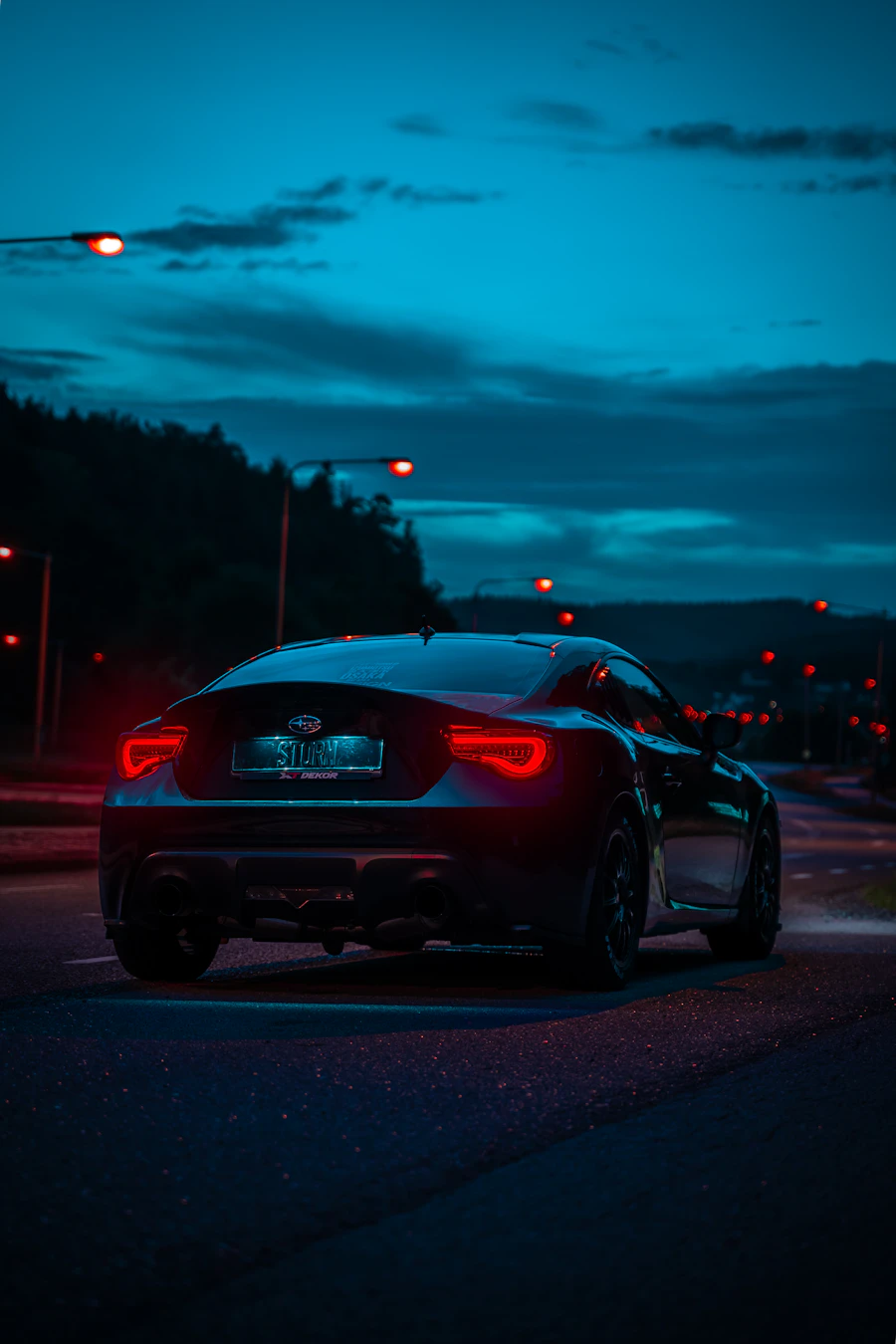 Car driving at night with headlights on
