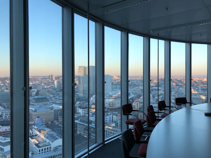 People working beside a large office window