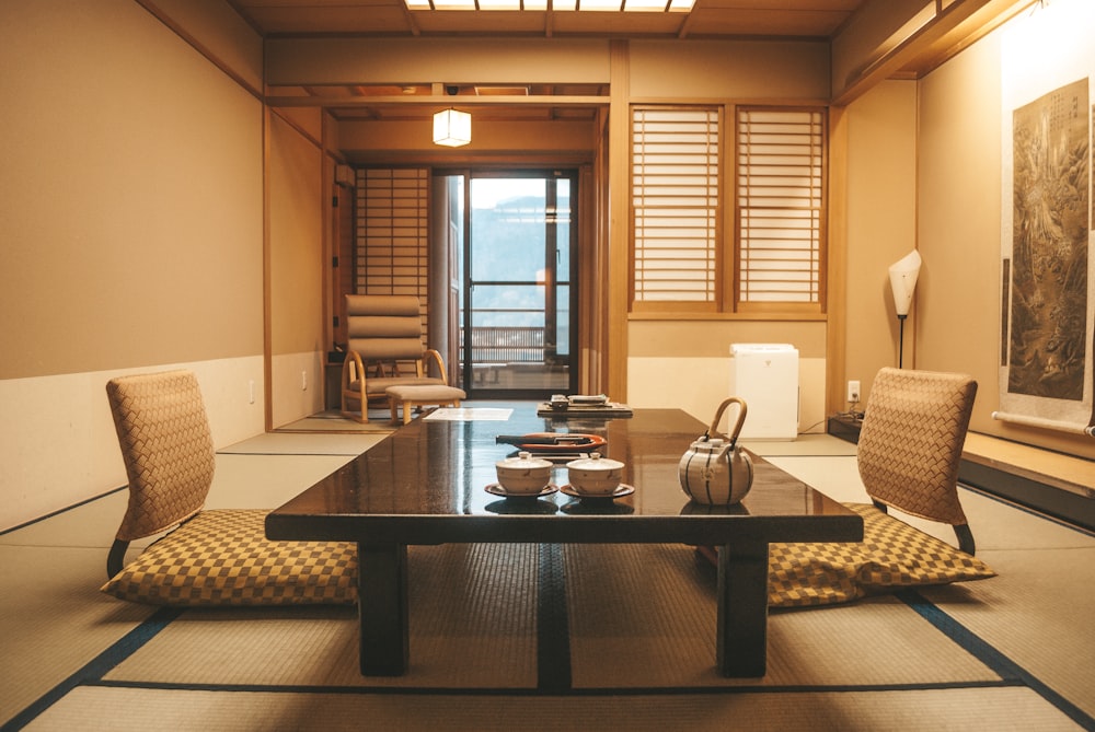 brown wooden table near window