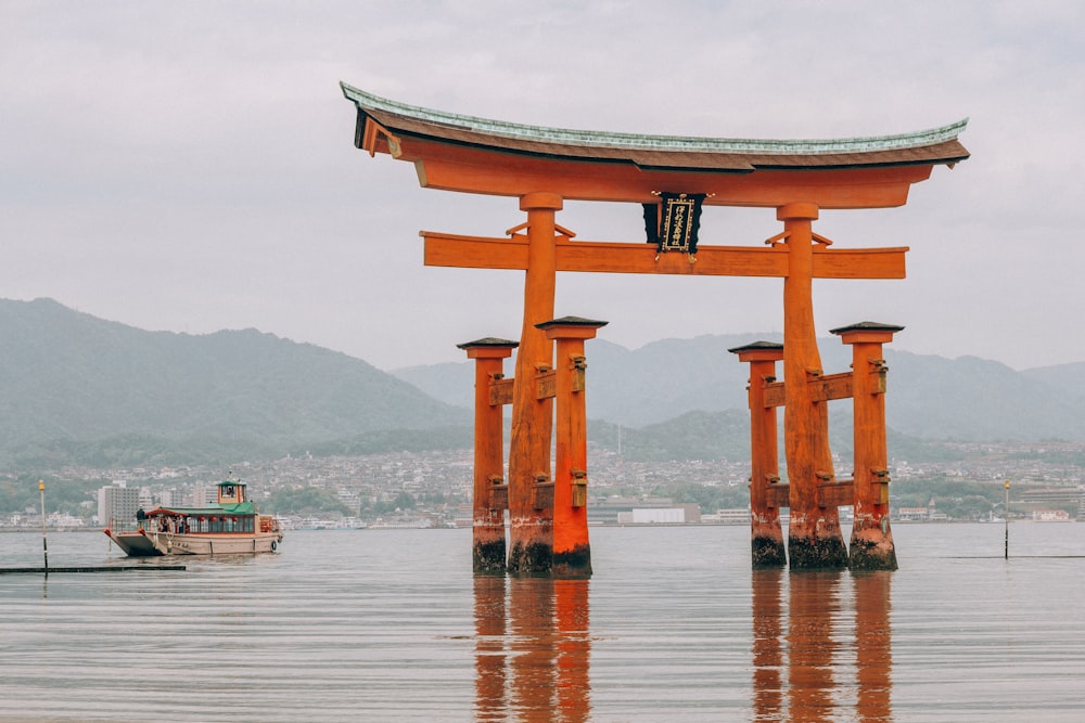 brown wooden arch on body of water during daytime