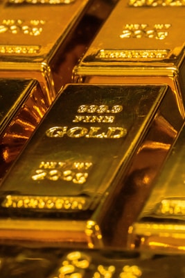 A single gold bar under harsh, shadowed light