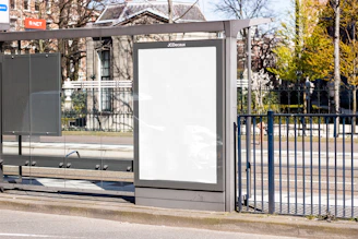 white board on black metal fence