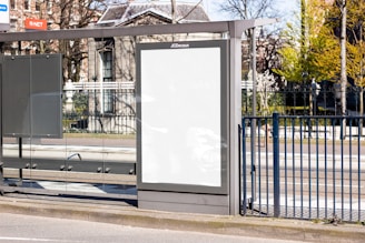 white board on black metal fence