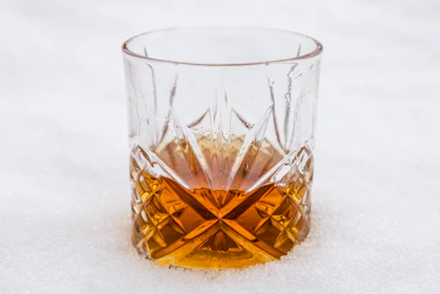 clear drinking glass with brown liquid