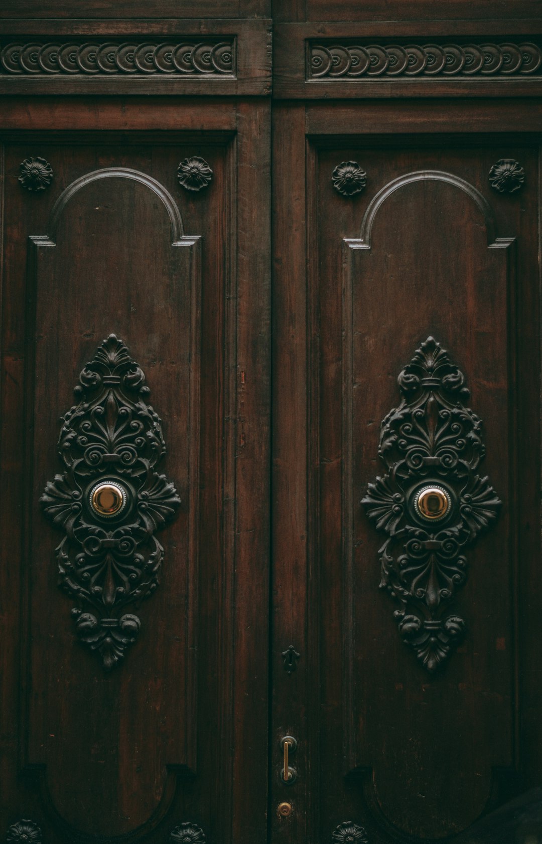 brown wooden door with black and white floral door handle