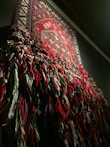 Close-up of a colorful decorative tapestry hanging on a wall