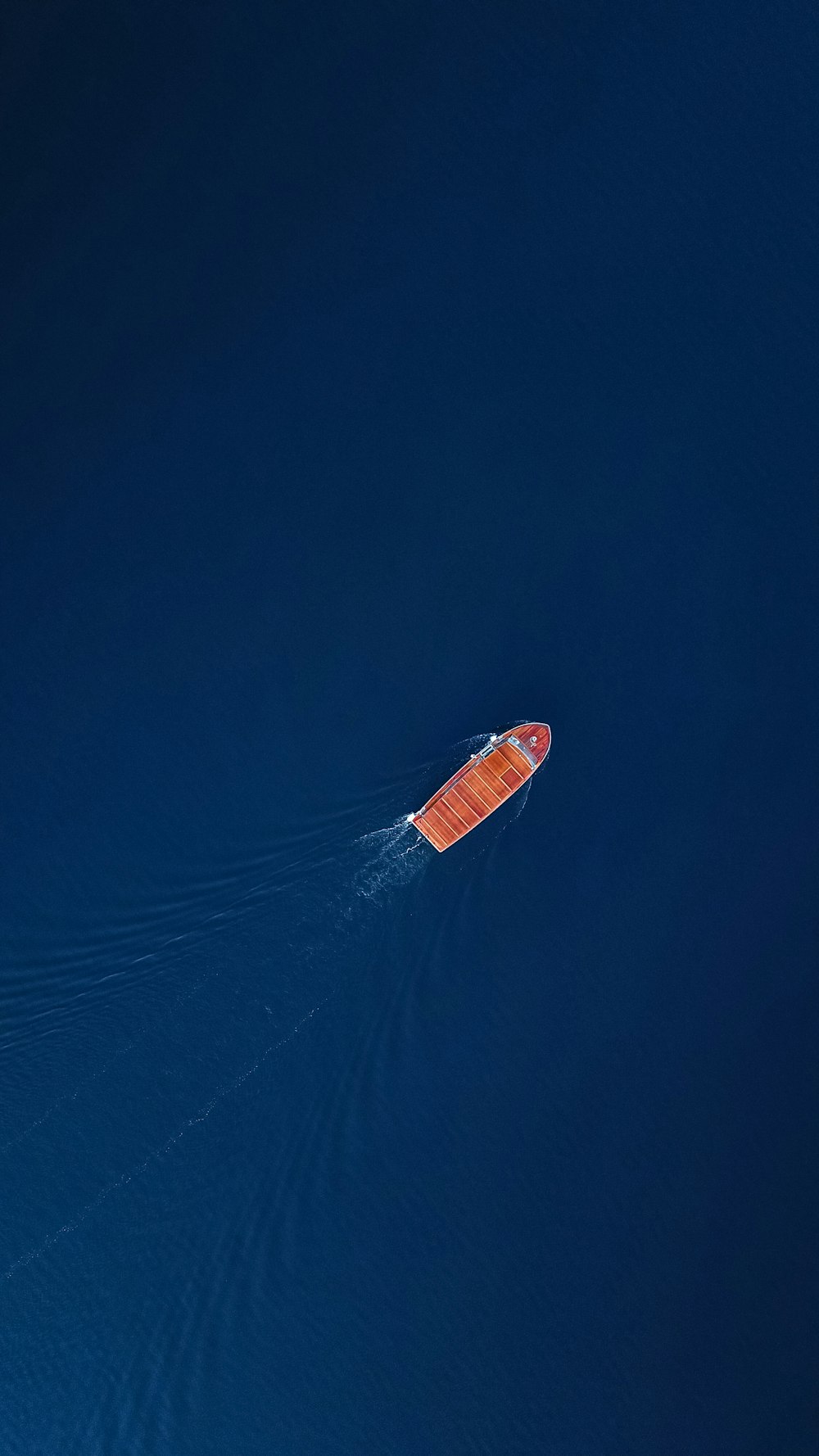 red and white boat on blue sky