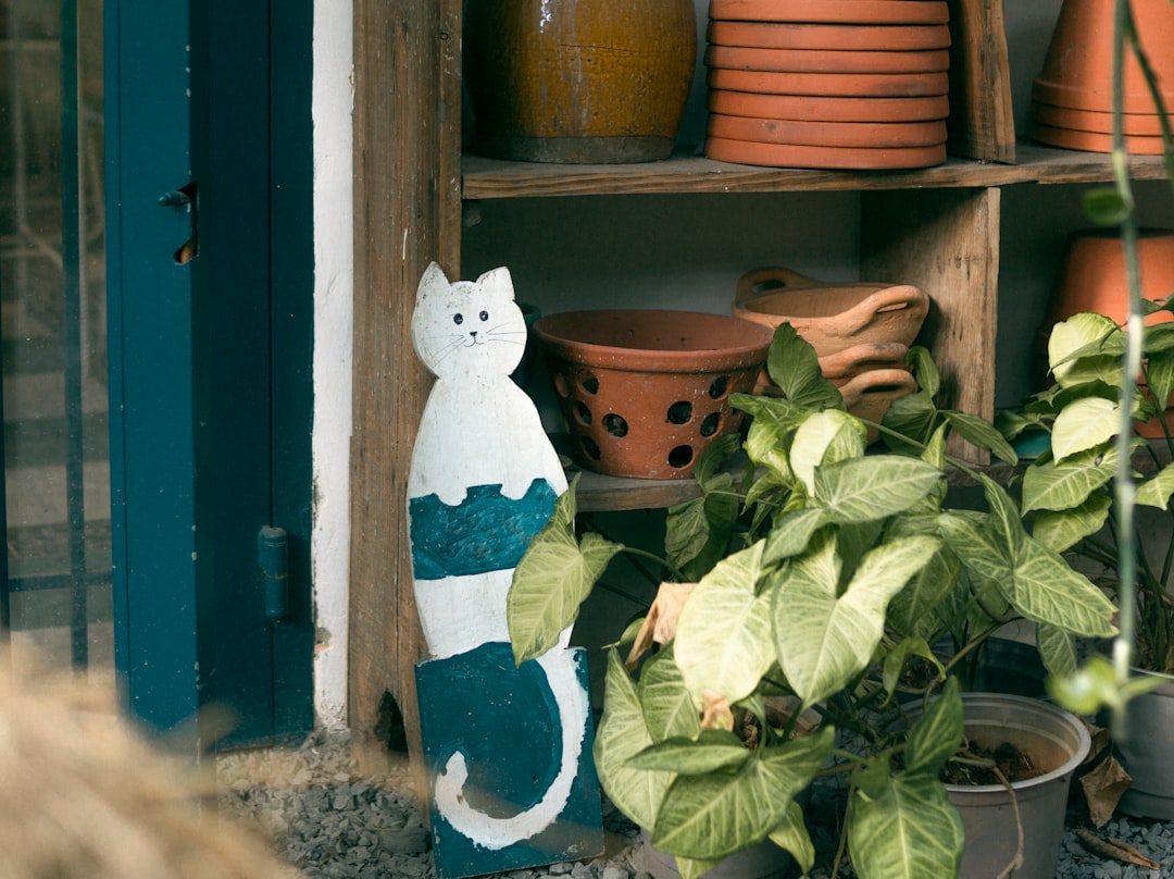 white snowman figurine beside brown wooden window