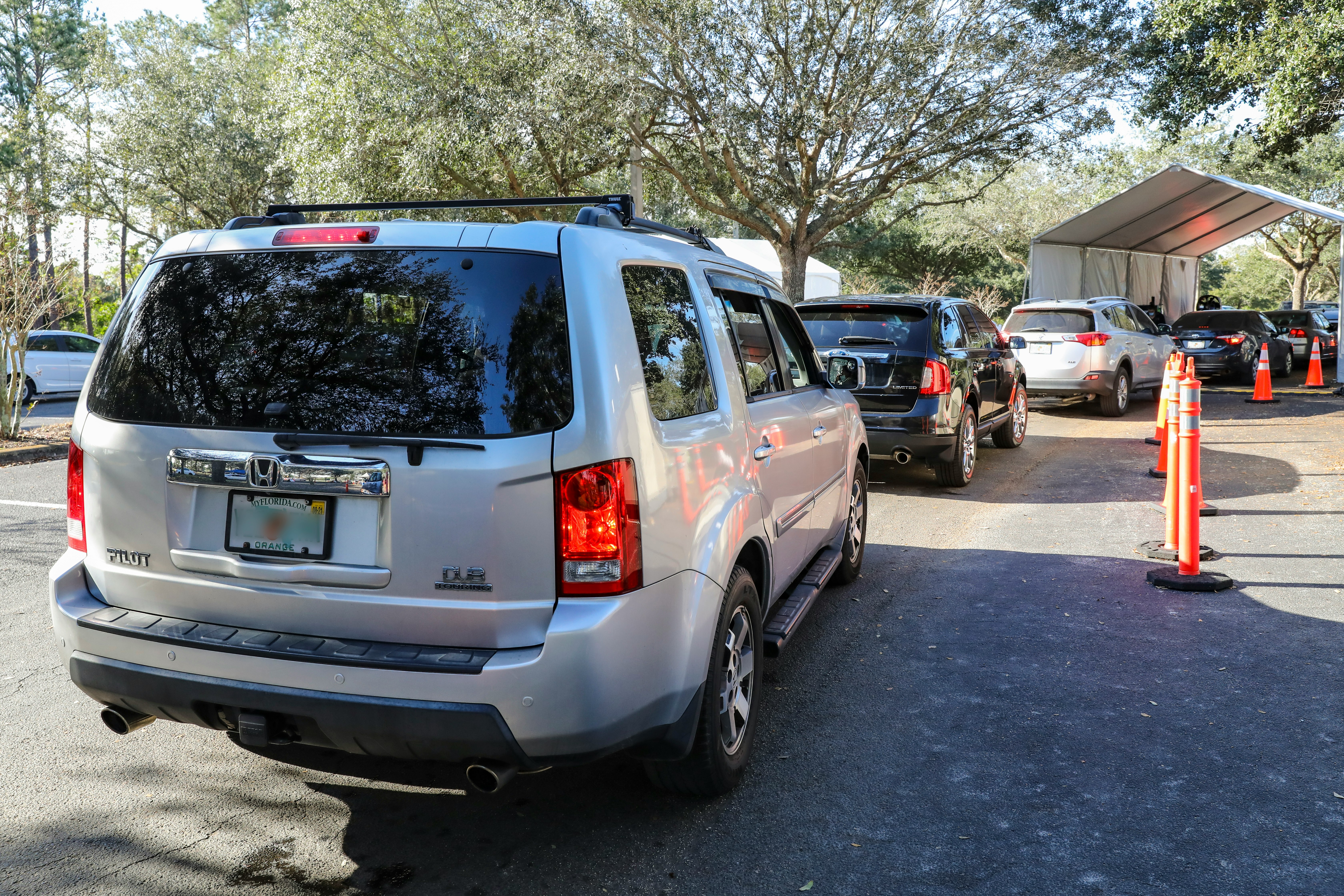 white suv parked on gray concrete road during daytime