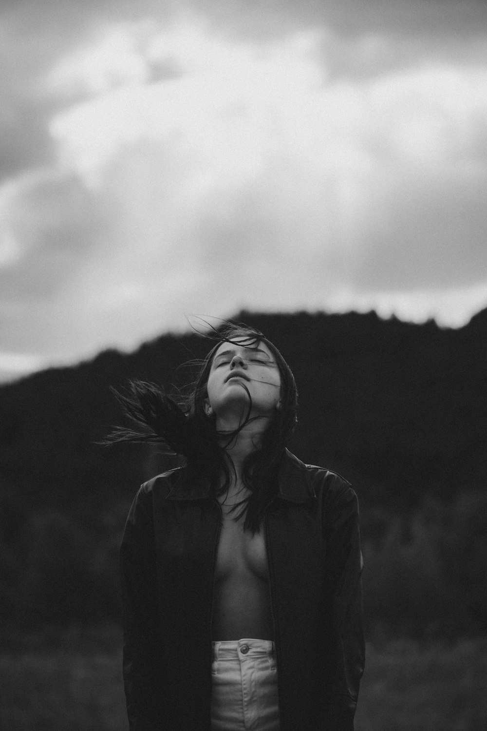 grayscale photo of woman in black coat