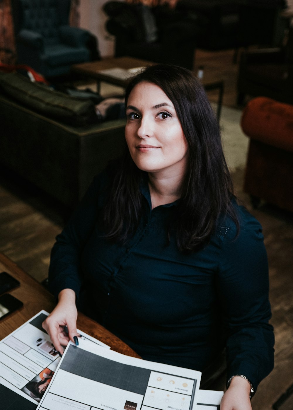 woman in blue long sleeve shirt sitting on chair