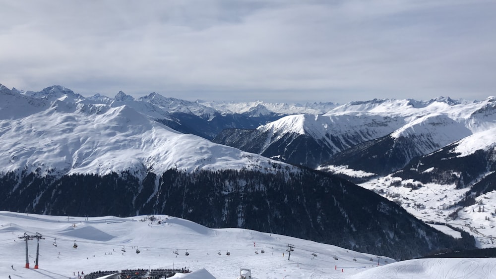 snow covered mountain under cloudy sky during daytime