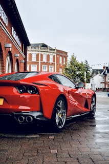 red ferrari 458 italia parked on street during daytime