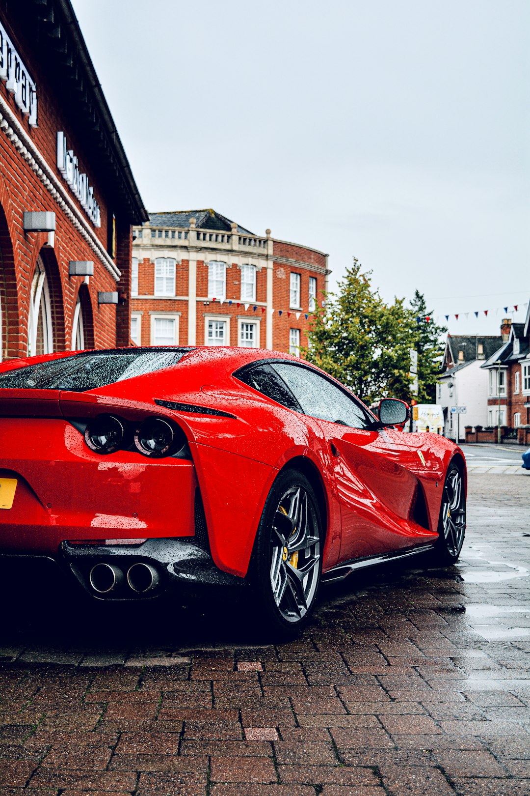 red ferrari 458 italia parked on street during daytime