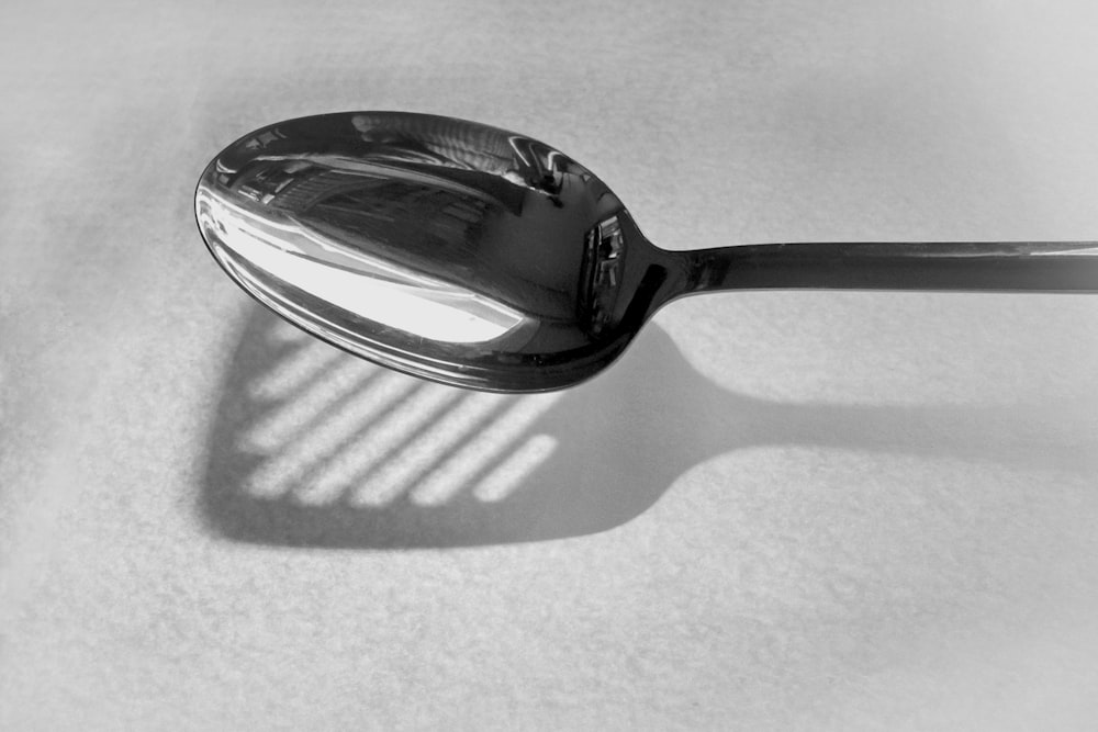 stainless steel spoon on white textile