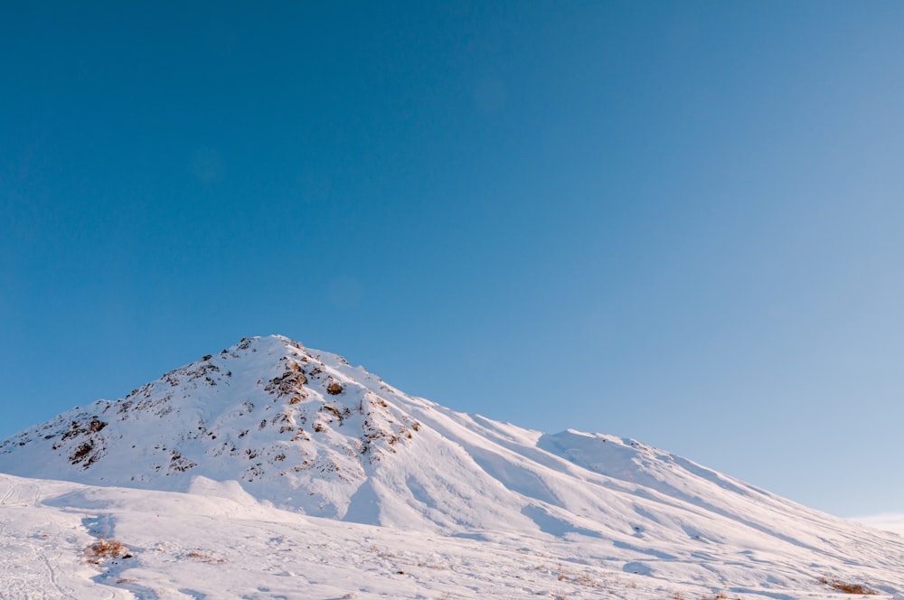 snow covered mountain under blue sky during daytime