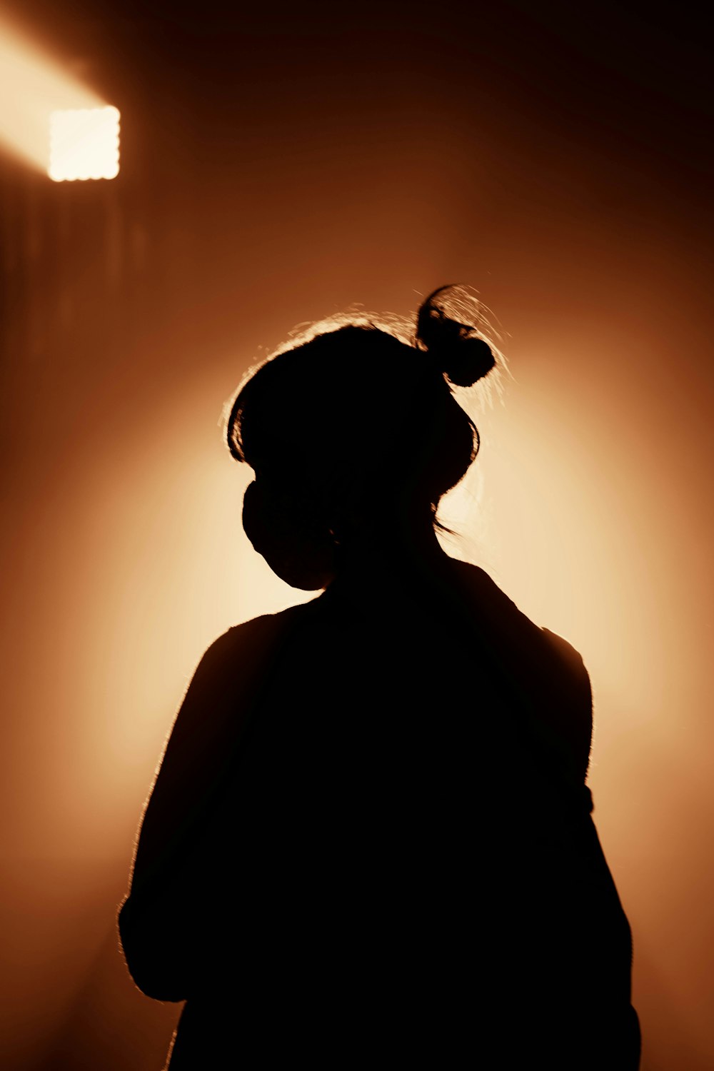 silhouette of woman standing during sunset