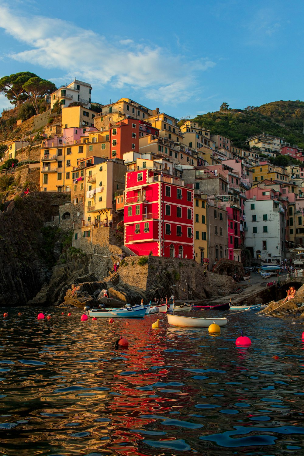 people riding on boat on river near buildings during daytime