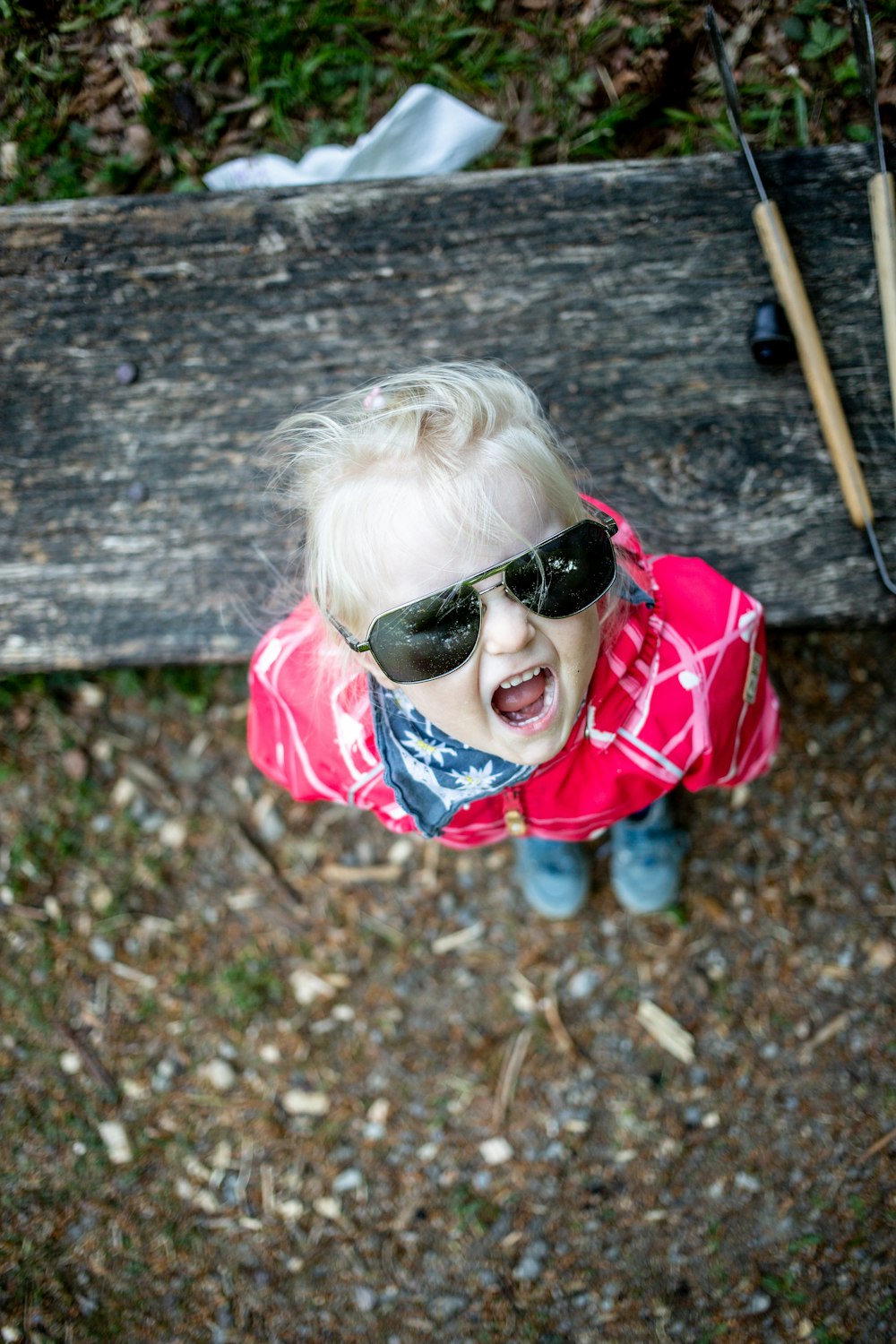 girl in red and white plaid dress shirt wearing black sunglasses