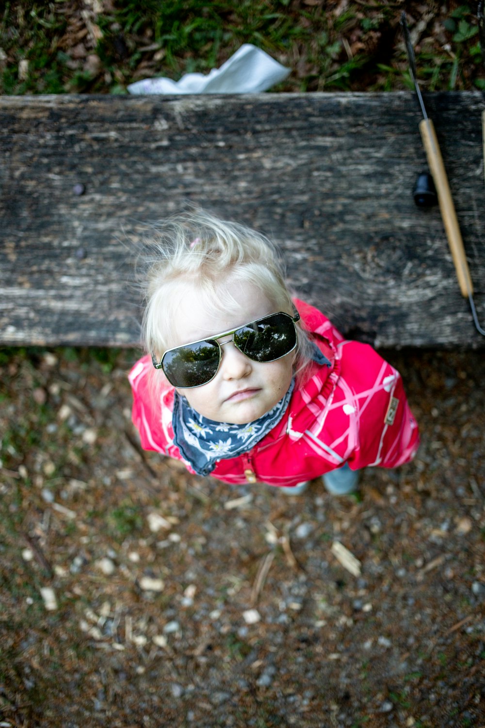 girl in red and white plaid shirt wearing black sunglasses