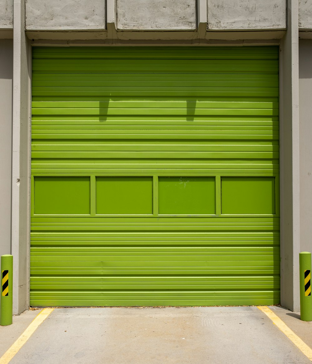 green wooden door on gray concrete floor