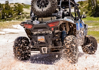 blue and black atv on white sand during daytime