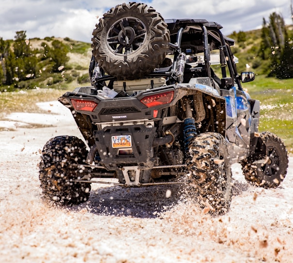 blue and black atv on white sand during daytime