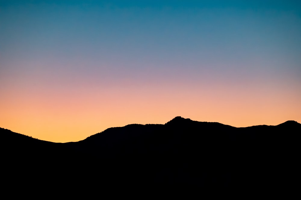 silhouette of mountain during sunset