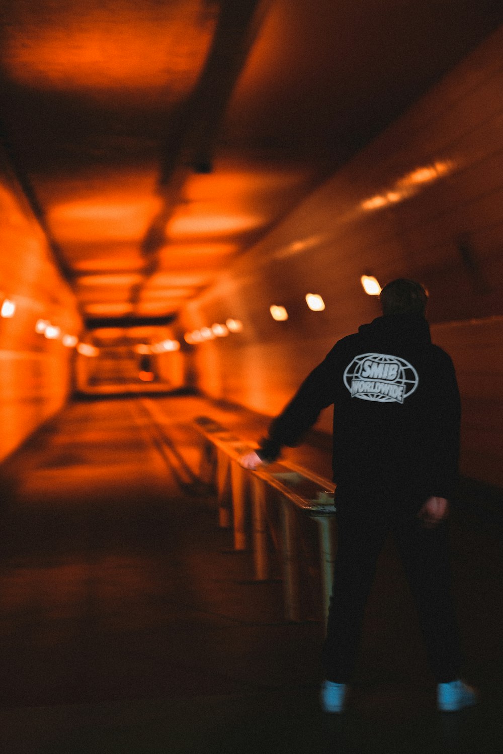 man in black jacket standing on hallway