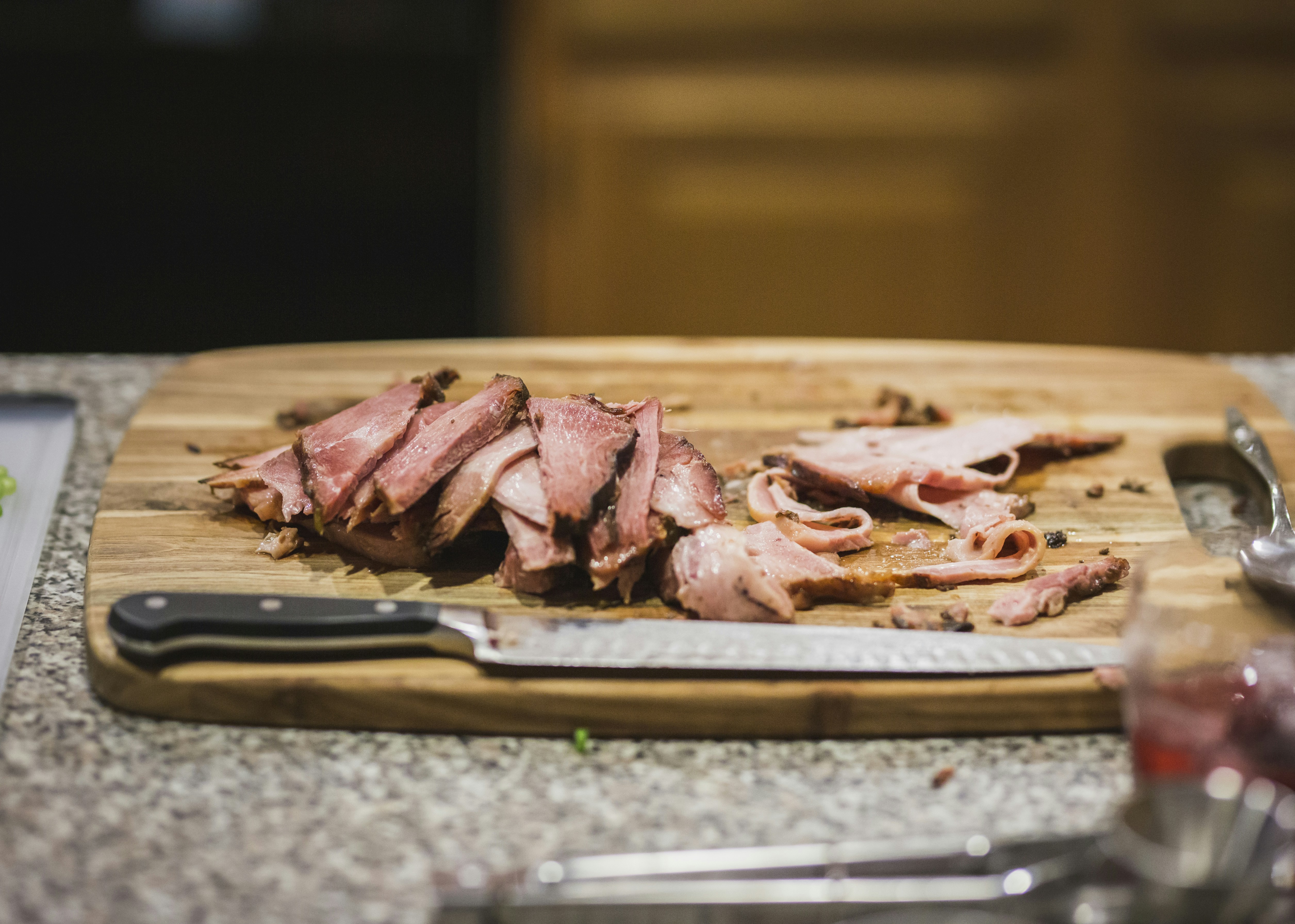 sliced raw meat on brown wooden tray
