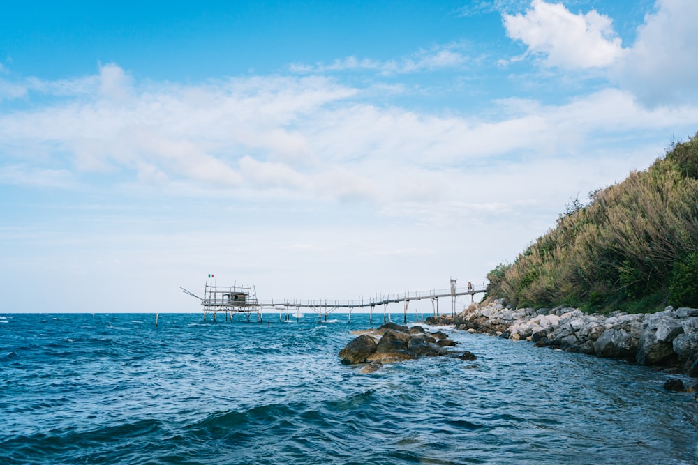 brown wooden dock on blue sea under blue sky during daytime