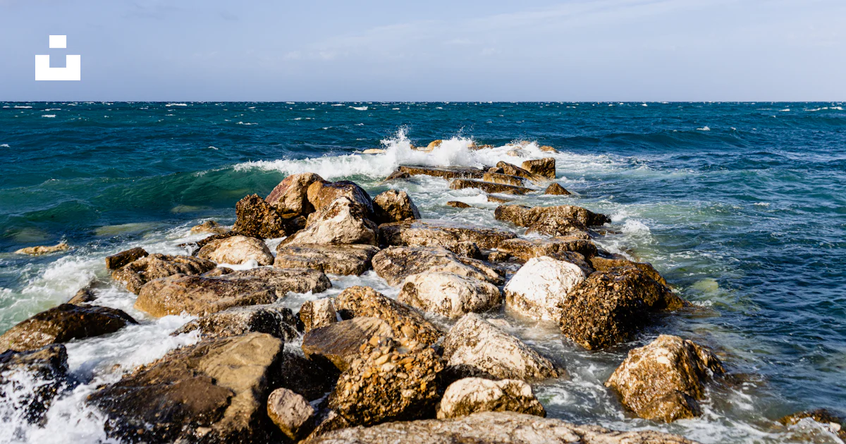 Brown rocks on sea shore during daytime photo – Free Beach landscape ...