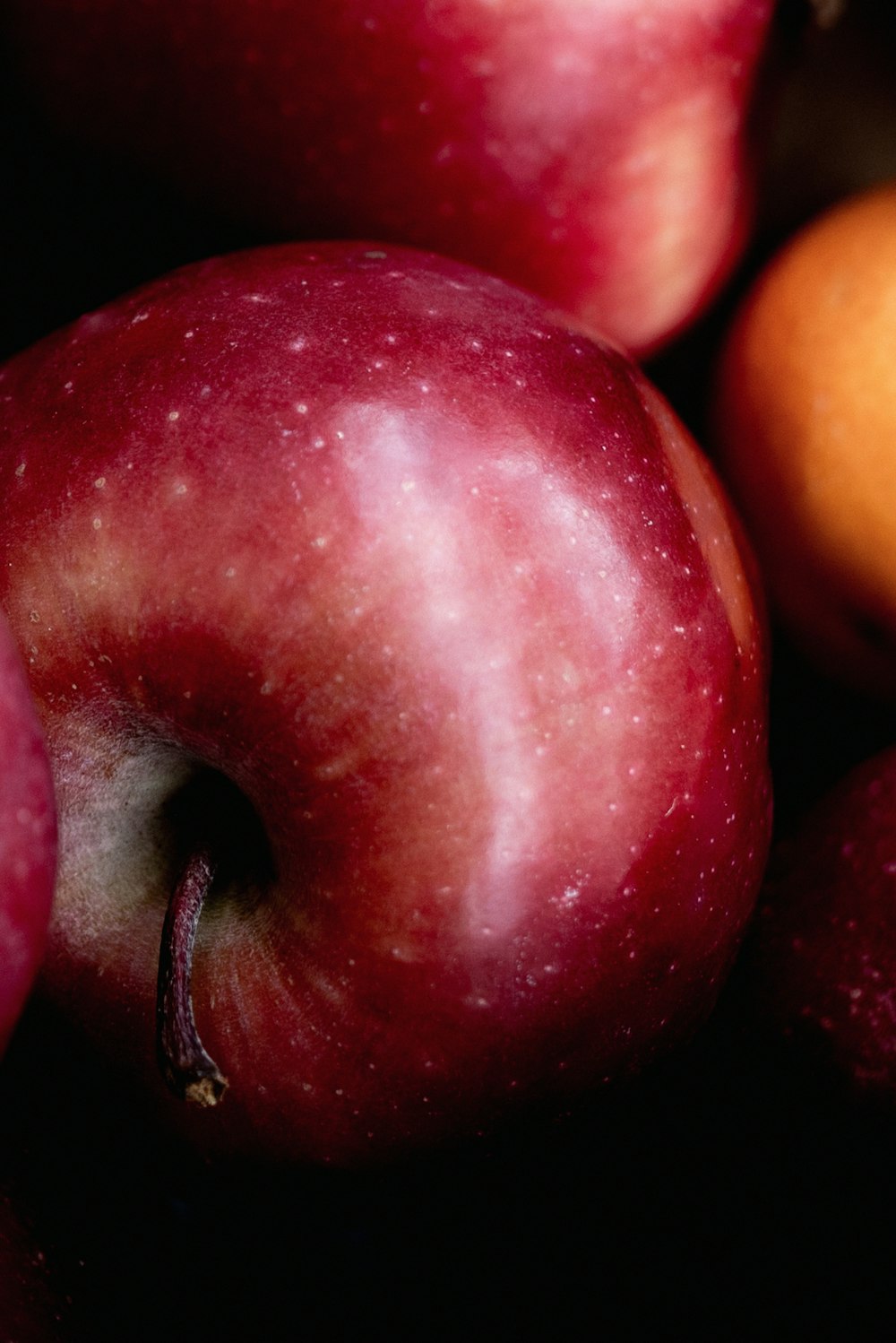 red apple fruit on black background