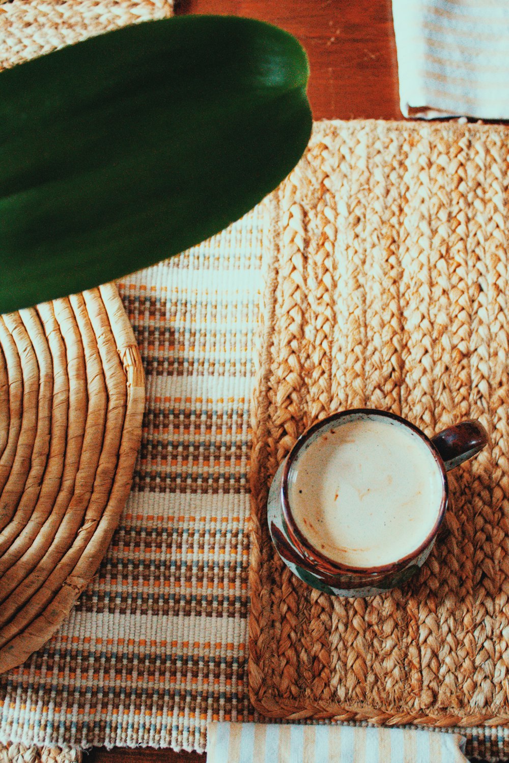 black ceramic mug on brown woven table mat