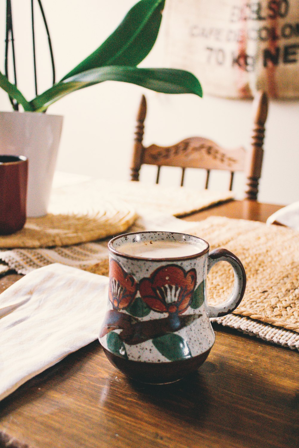 white red and blue ceramic mug on brown wooden table