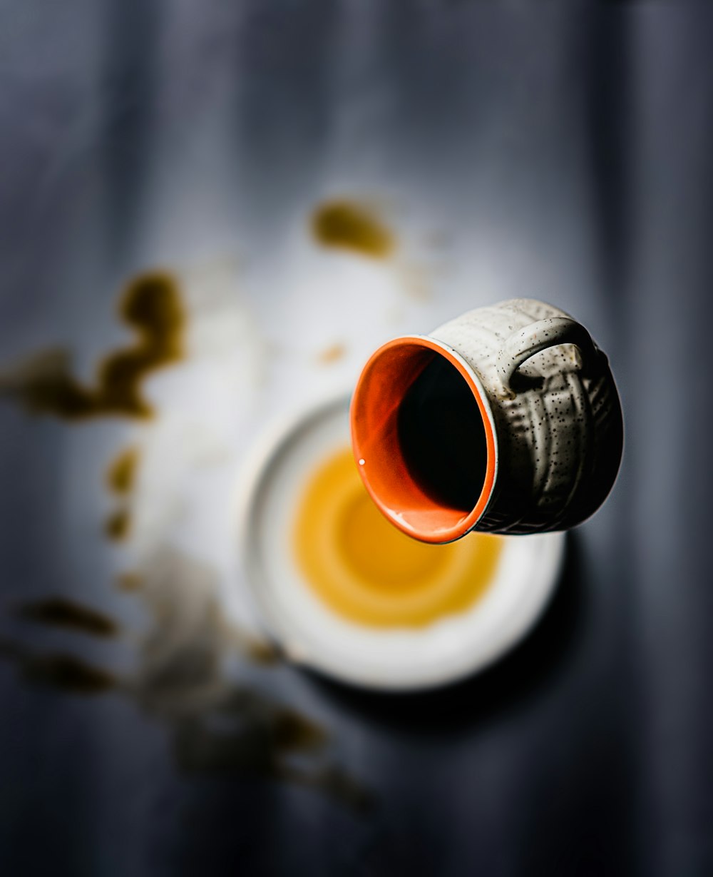 black and orange bottle on white table