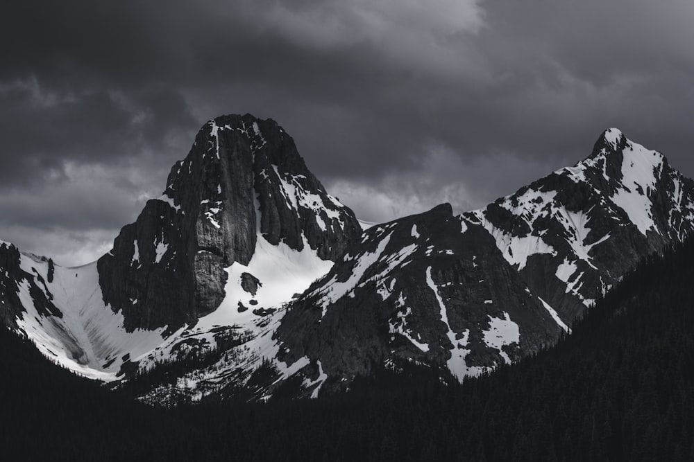 snow covered mountain under cloudy sky