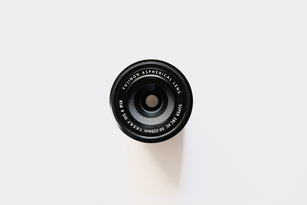 black camera lens on white surface