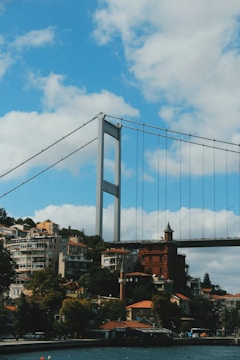 gray bridge under white clouds during daytime