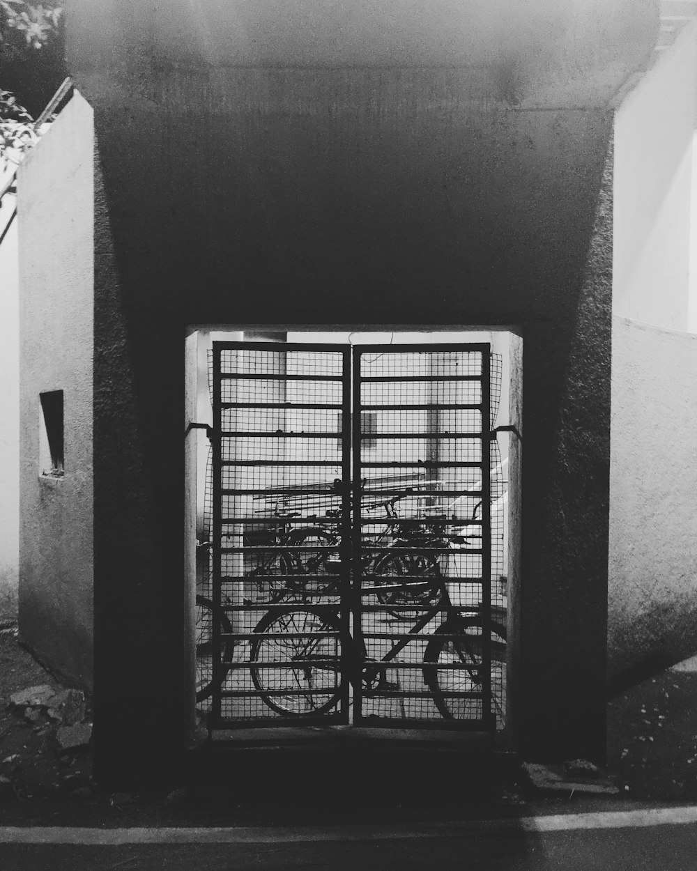 grayscale photo of metal gate